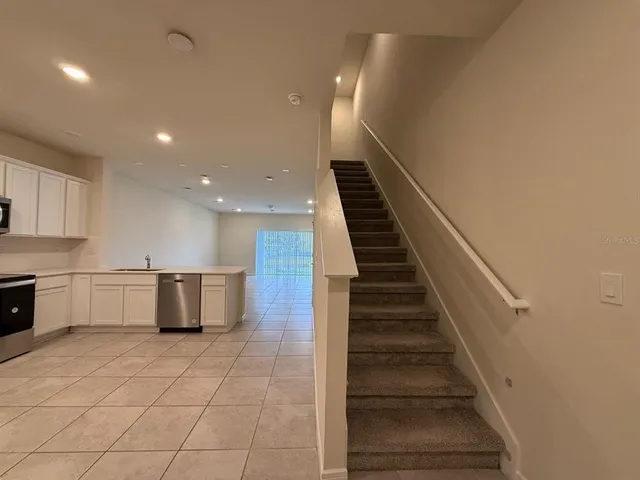 a view of kitchen with microwave and refrigerator