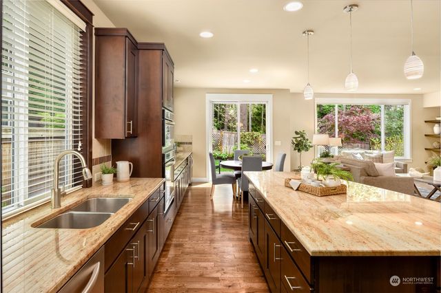 a kitchen with granite countertop a sink and a stove