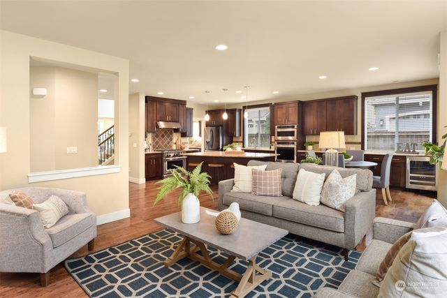 a living room with furniture and kitchen view