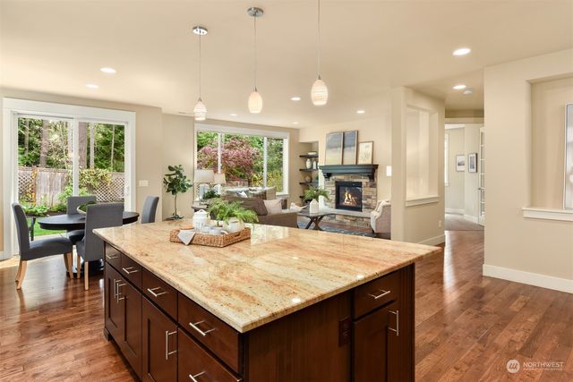 a kitchen with granite countertop kitchen island a sink table and chairs