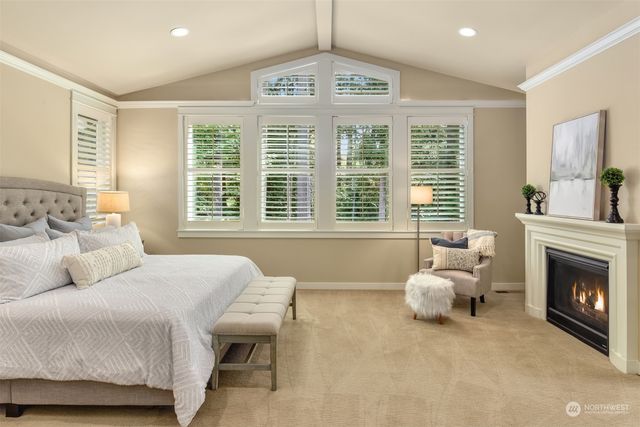 a bedroom with a bed and a large window