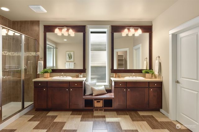 a large bathroom with a double vanity sink mirror and a bathtub