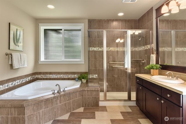 a bathroom with a tub a sink and a shower