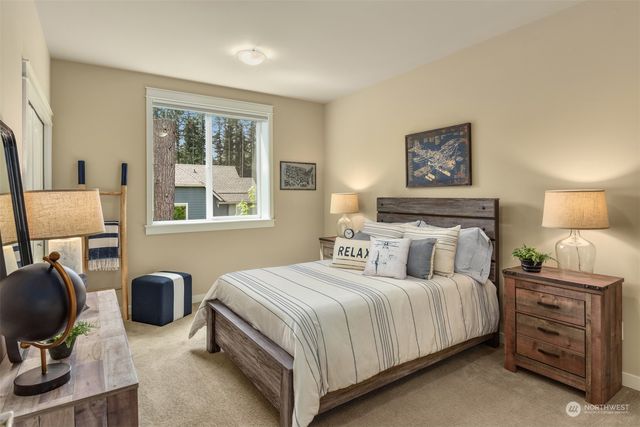 a bedroom with a bed and dresser next to a window