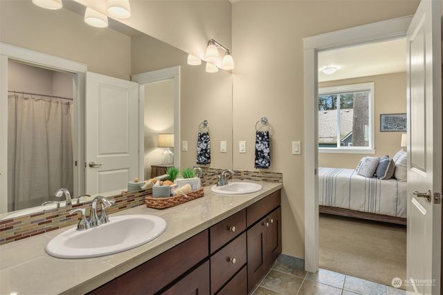 a bathroom with double vanity sinks and a mirror