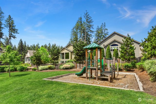 a view of a chair and table in backyard of the house