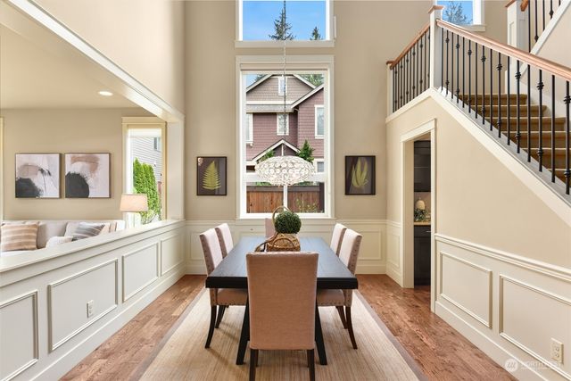 a dining room with furniture a window and wooden floor