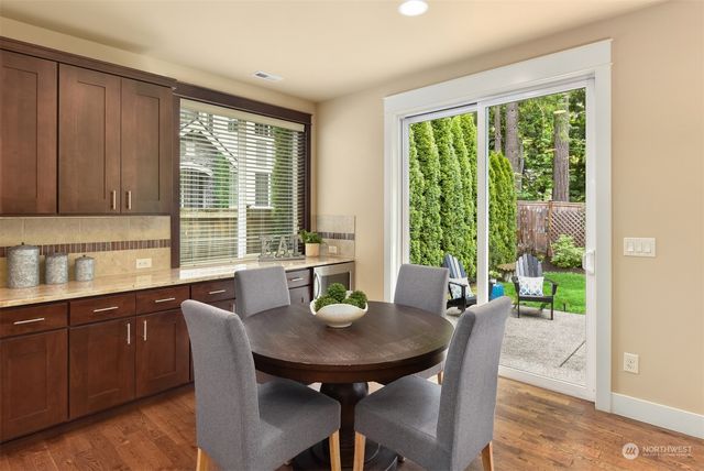 a view of a dining room with furniture and window