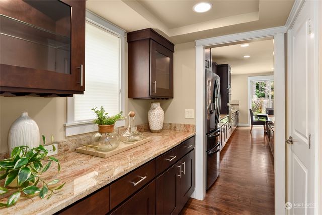 a hallway with sink and lots of wooden cabinets
