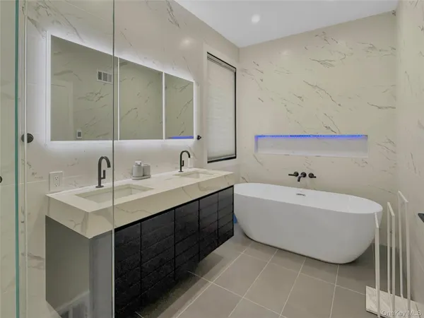 a bathroom with a shower sink vanity granite and mirror