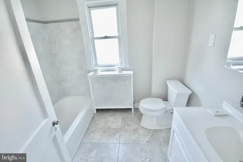a bathroom with a bathtub and toilet