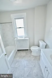 a bathroom with a shower and a bath tub