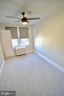 a view of a livingroom with couch and floor to ceiling window