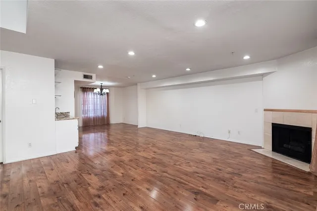 a view of a kitchen with wooden floor and a sink