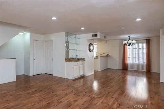 a kitchen with granite countertop a stove sink and microwave