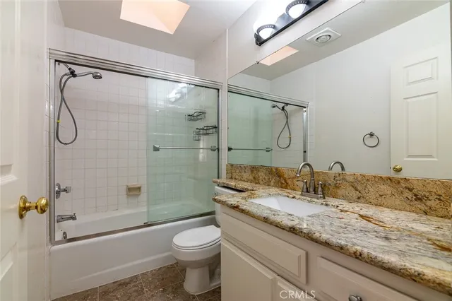 a view of a hallway with closet and bathroom