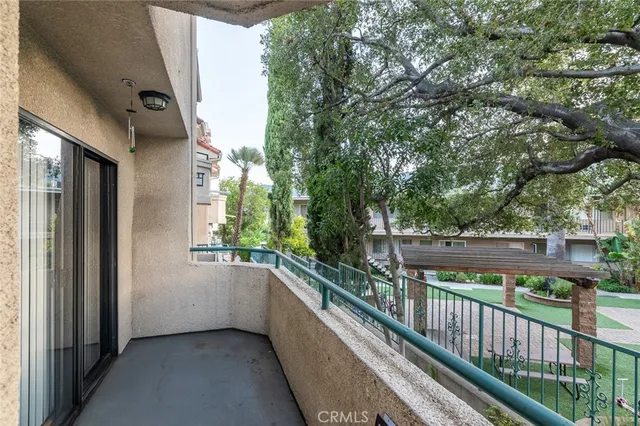 a view of a balcony with trees