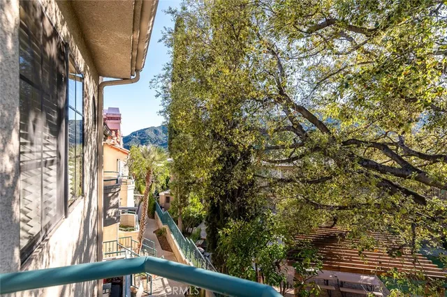 a view of mountain with a couple of trees in the background