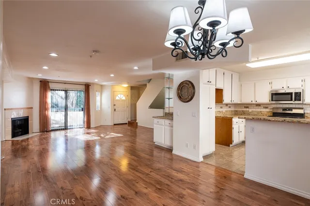 a view of a kitchen with a sink cabinets and wooden floor
