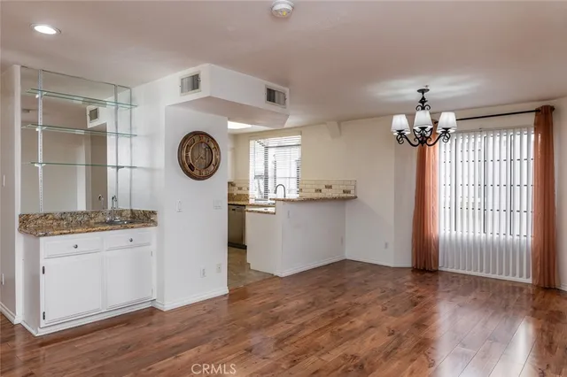 a room with kitchen island and wooden floor