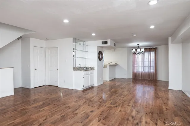 a view of empty room with wooden floor and fireplace