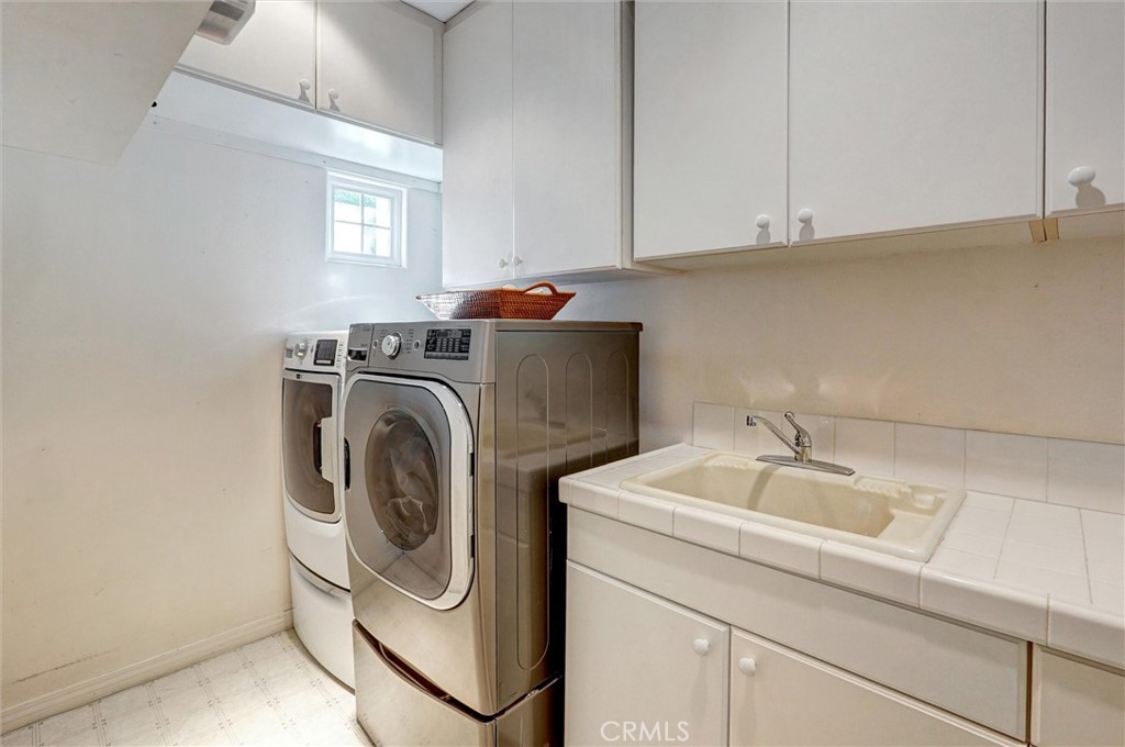 14079 Stagecoach Trail Moorpark, CA 93021 - Photo 20 of 47 a utility room with sink dryer and washer