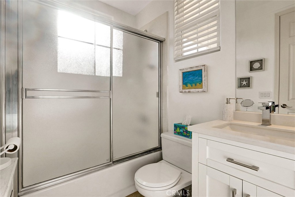 14079 Stagecoach Trail Moorpark, CA 93021 - Photo 28 of 47 a bathroom with a sink a mirror toilet and shower