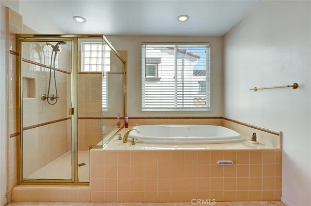 a bathroom with a bathtub and a shower
