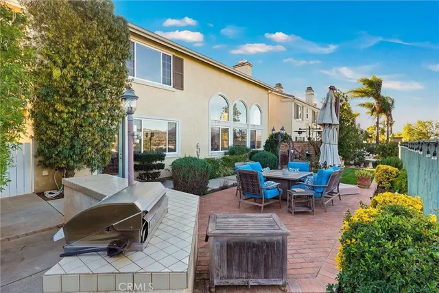 a swimming pool with outdoor seating and a potted plant