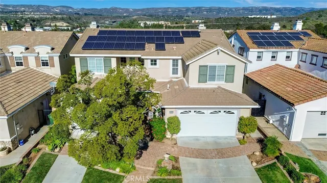 an aerial view of a houses with a yard