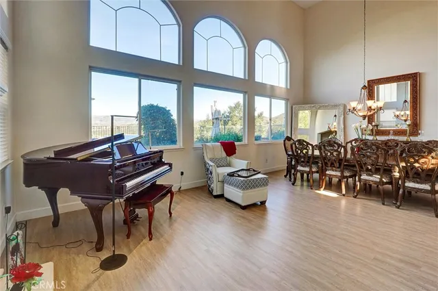 a living room with furniture pool table and wooden floor