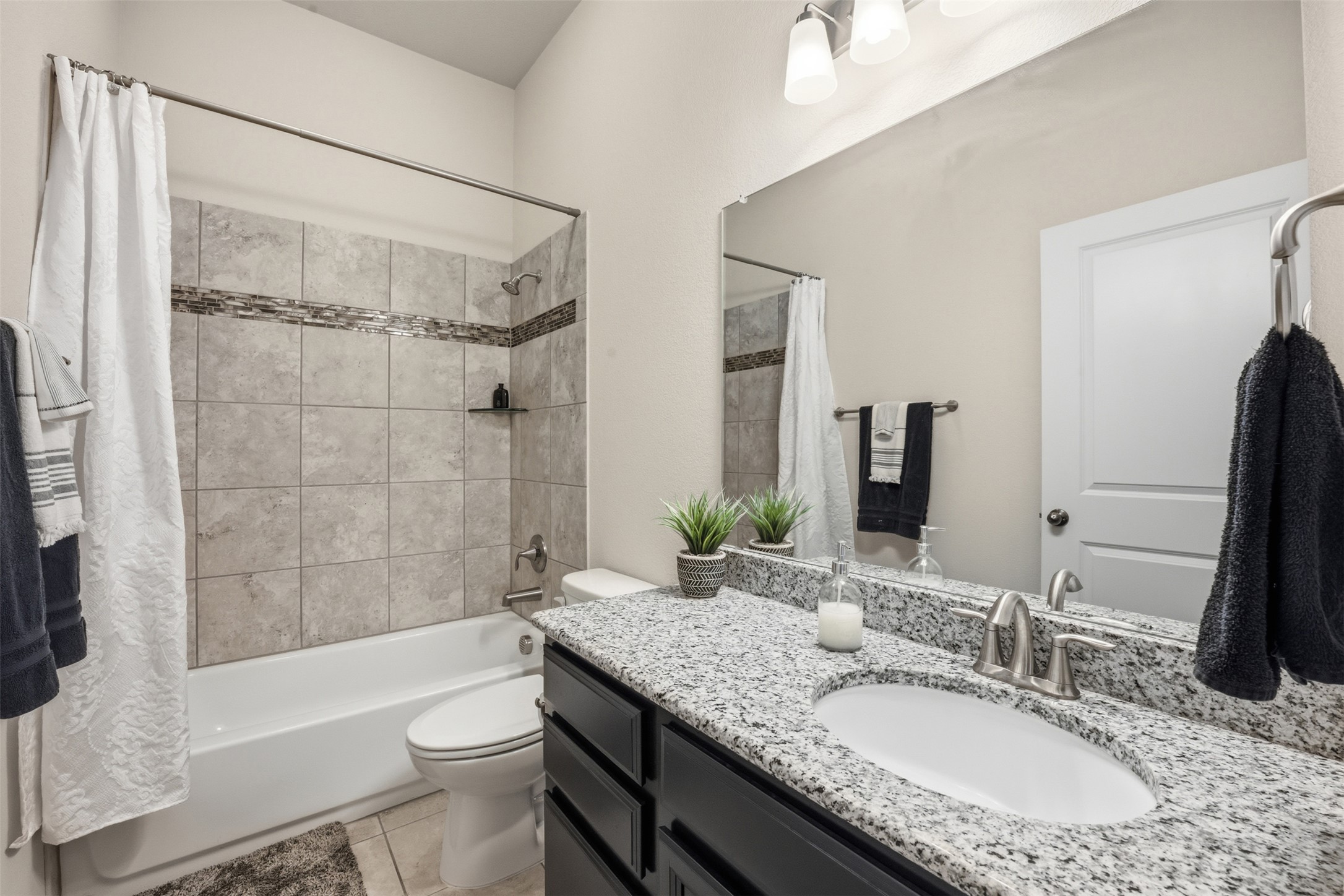 276 Gunnison Way Kyle, TX 78640 - Photo 17 of 28 a bathroom with a granite countertop tub sink toilet and shower