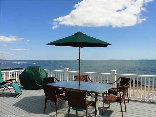 a view of a roof deck with furniture