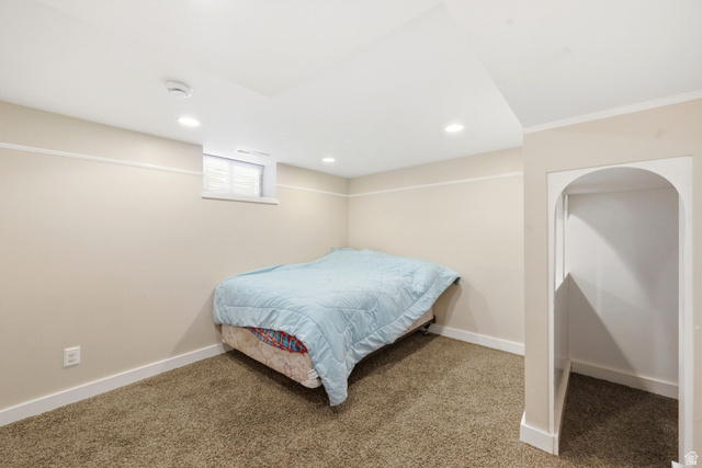 310 East 600 South Centerville, UT 84014 - Photo 23 of 41 Carpeted room featuring a window, recessed lighting, and an arched alcove