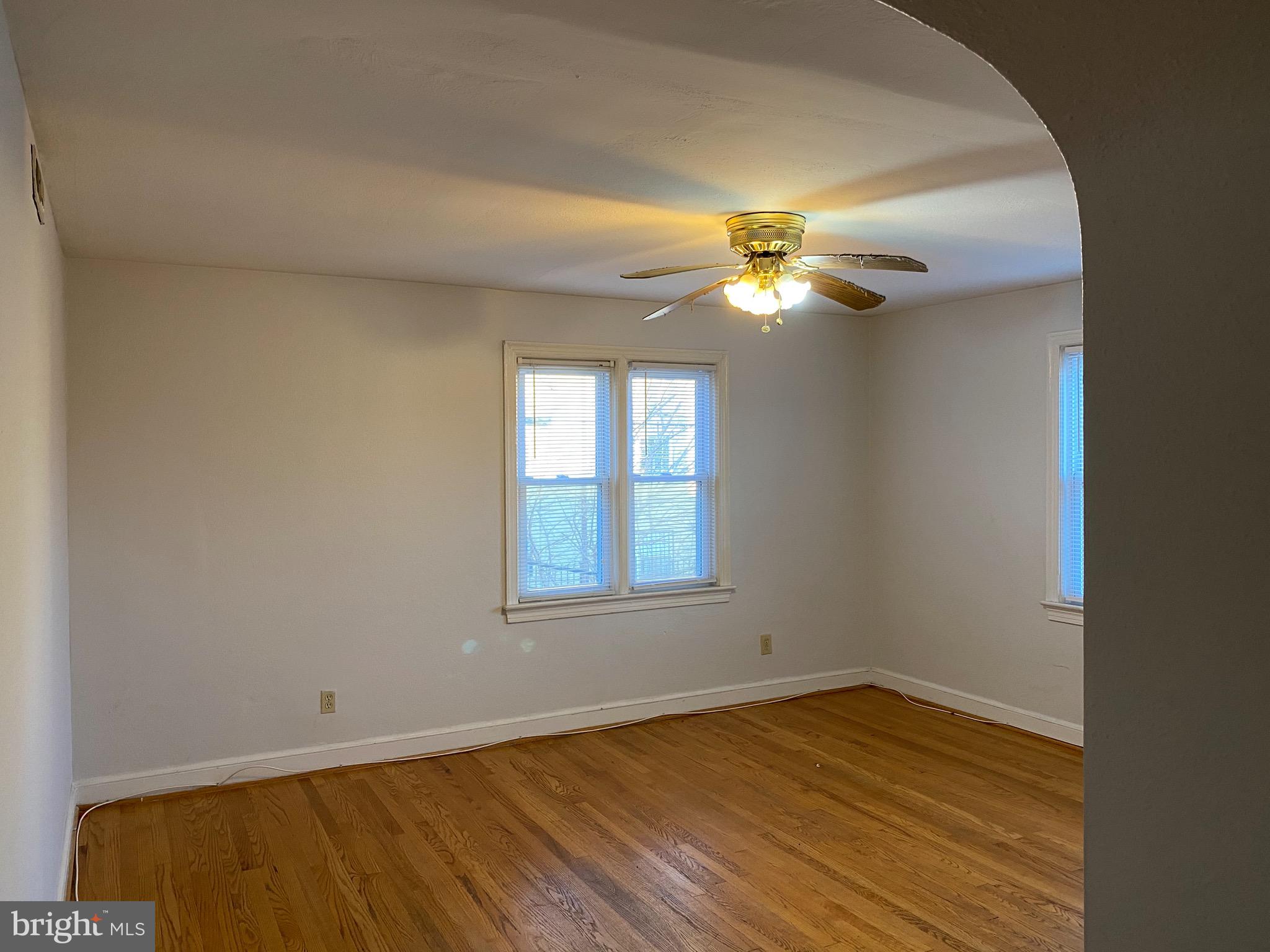 4236 Benning Road Northeast, Unit 302 Washington, DC 20019 - Photo 4 of 12 an empty room with a window and a ceiling fan