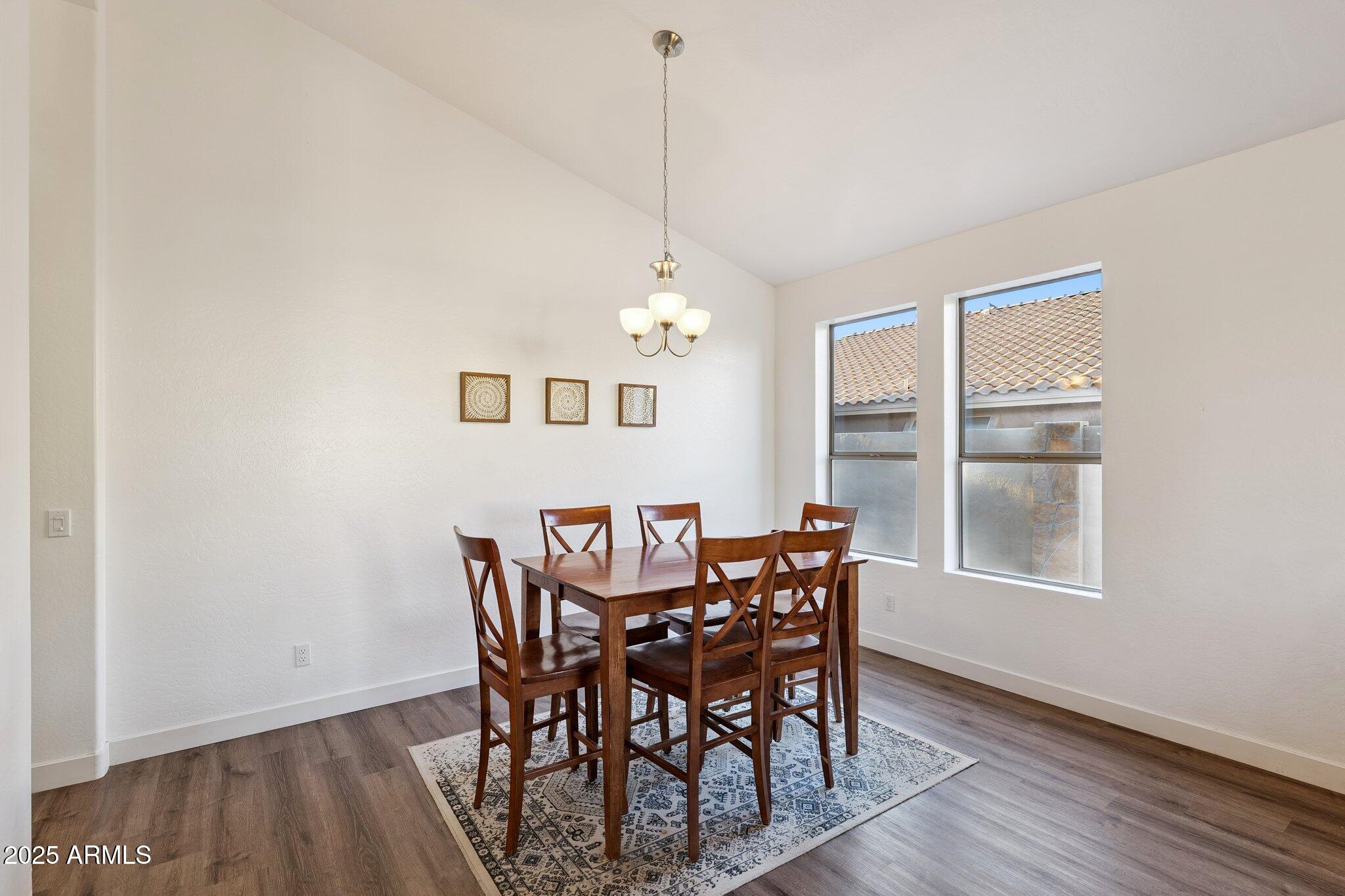 15608 South 7th Street Phoenix, AZ 85048 - Photo 10 of 30 a view of a dining room with furniture window and wooden floor
