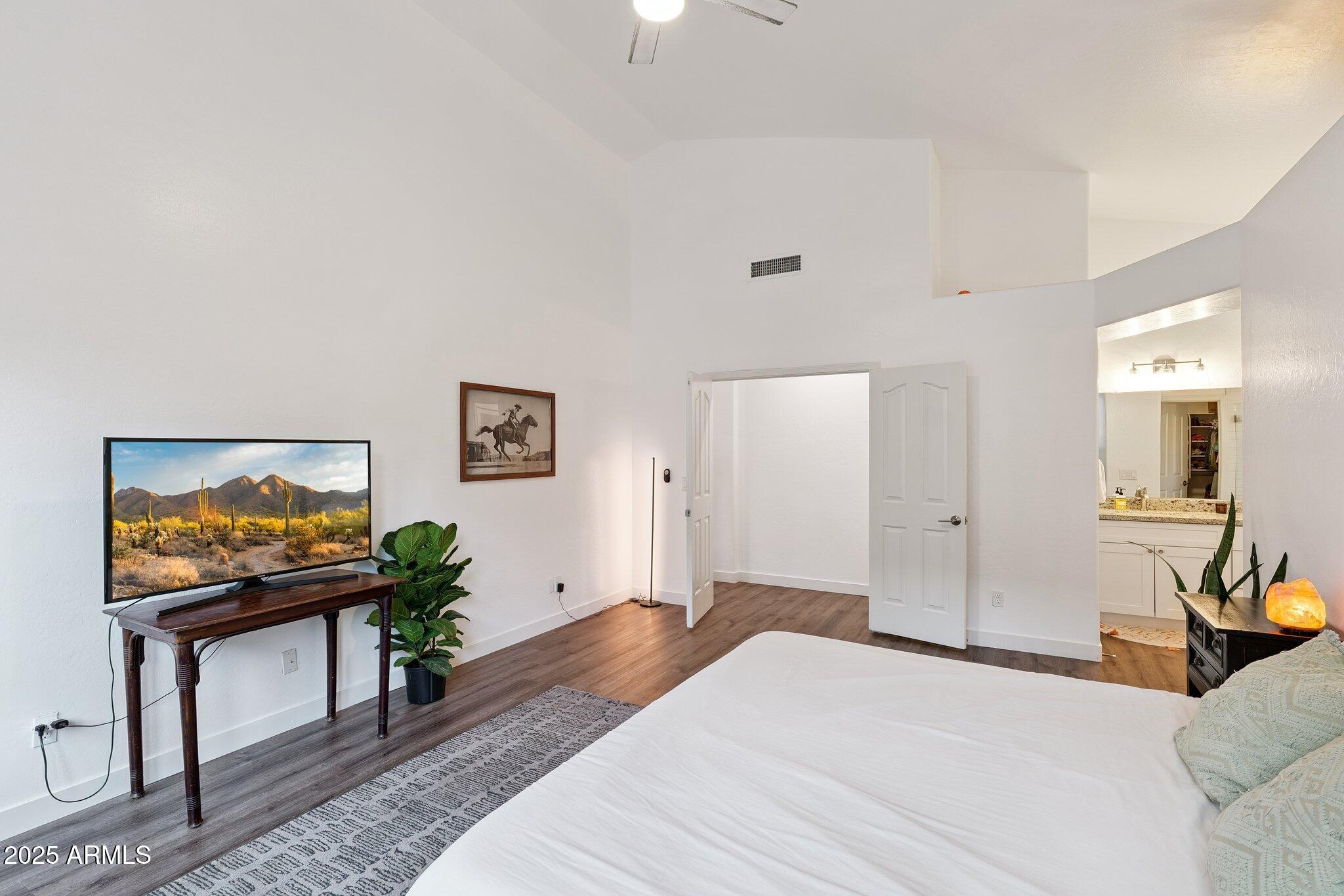 15608 South 7th Street Phoenix, AZ 85048 - Photo 12 of 30 a bedroom with a bed and a flat screen tv