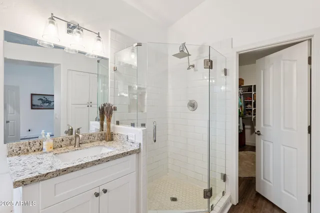 a bathroom with a granite countertop sink mirror and bathtub