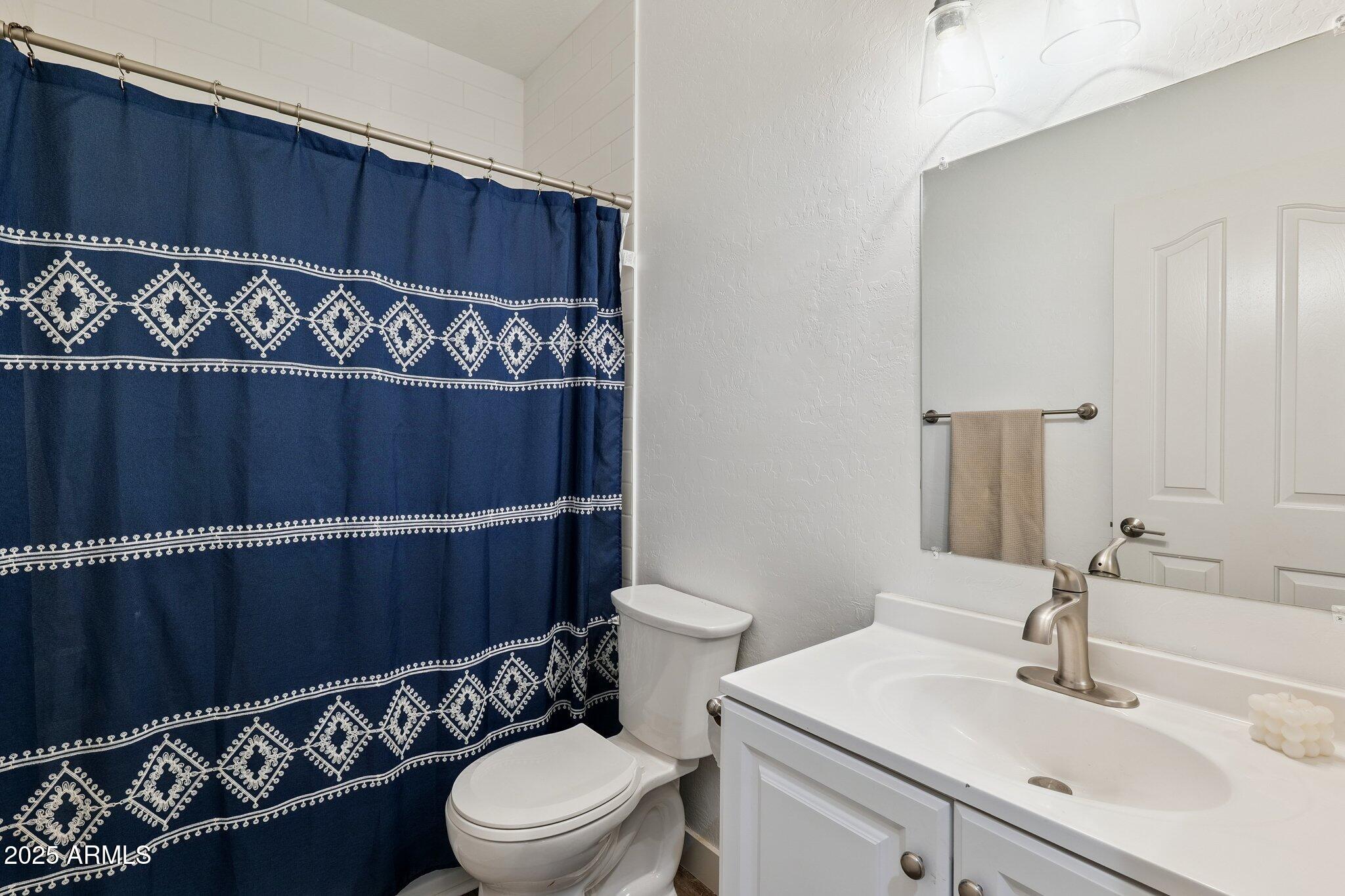 15608 South 7th Street Phoenix, AZ 85048 - Photo 18 of 30 a bathroom with a sink mirror vanity and toilet