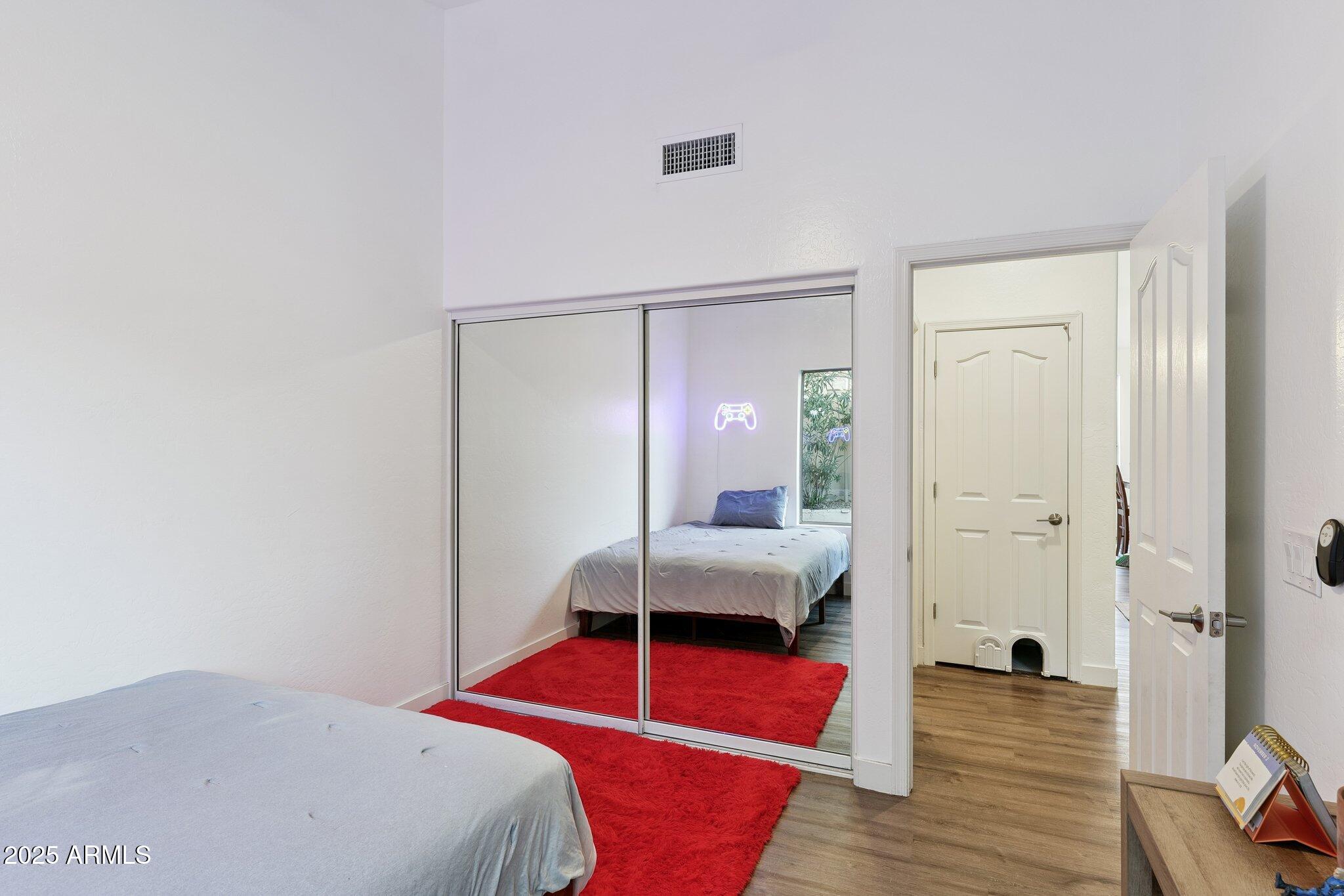 15608 South 7th Street Phoenix, AZ 85048 - Photo 20 of 30 a bedroom with a bed and wooden floor