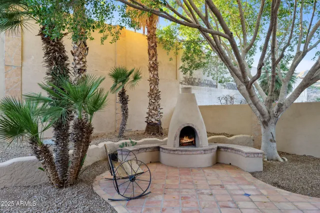 a backyard of a house with table and chairs