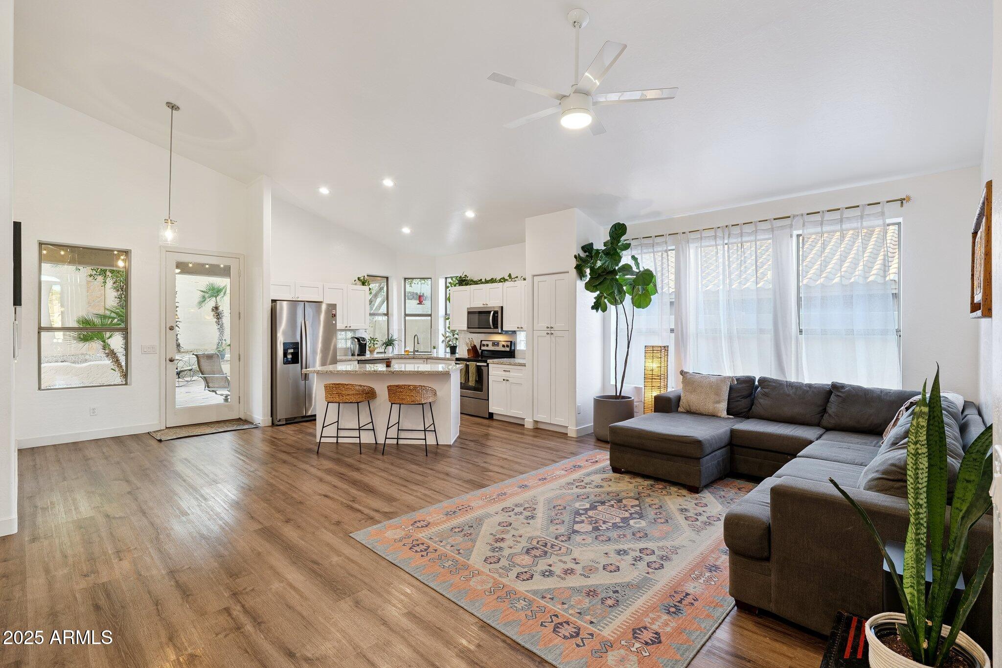 15608 South 7th Street Phoenix, AZ 85048 - Photo 3 of 30 a living room with furniture and a chandelier
