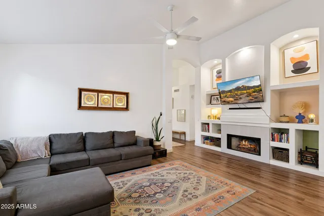 a living room with furniture and a chandelier