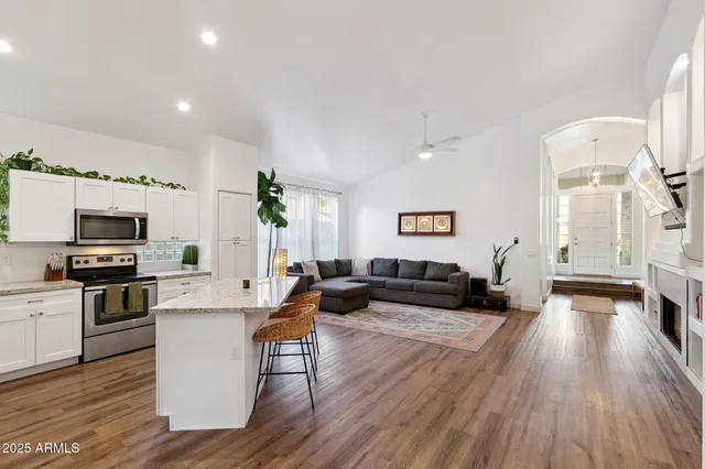 a living room with furniture and a fireplace