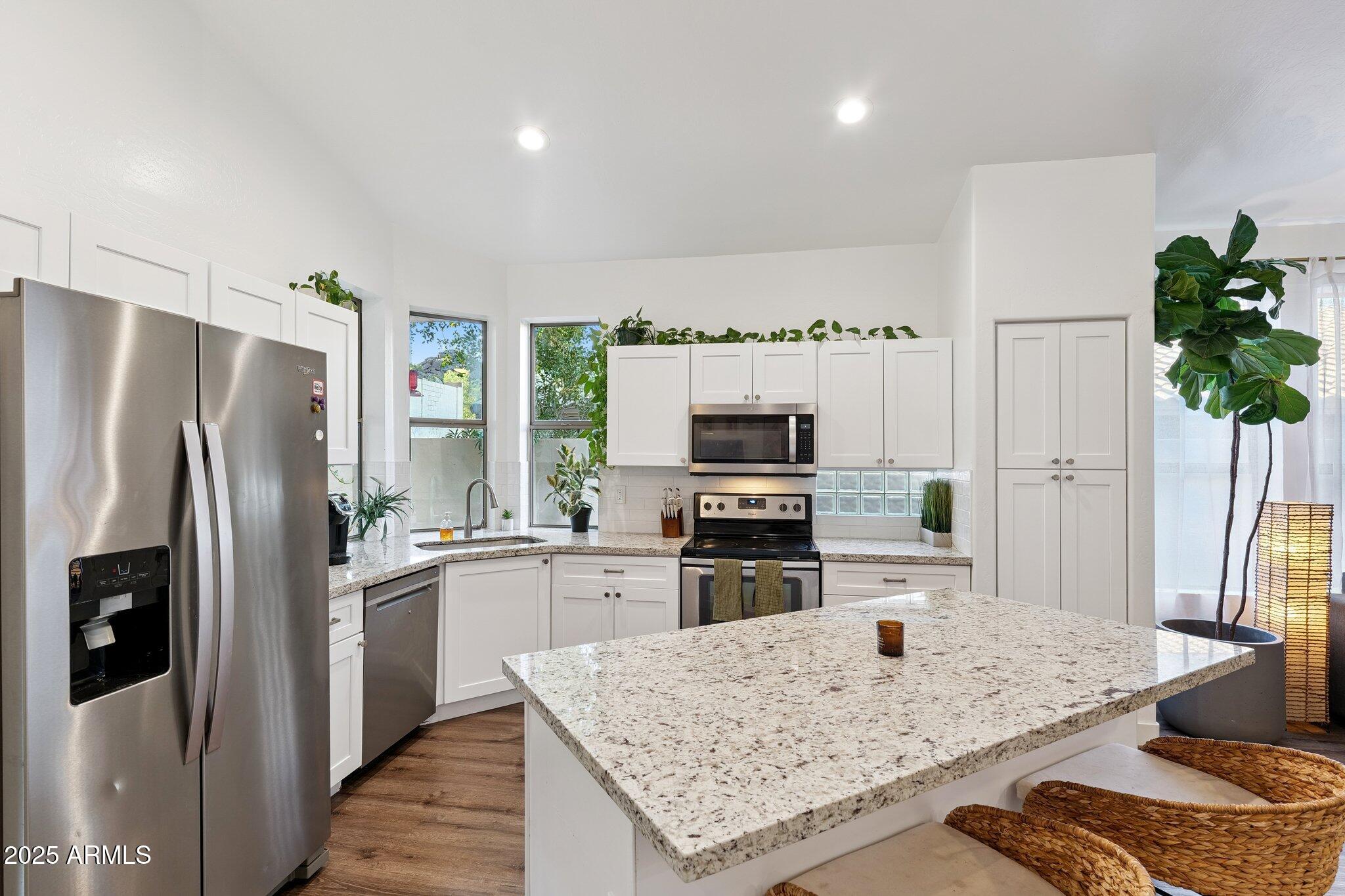 15608 South 7th Street Phoenix, AZ 85048 - Photo 6 of 30 a kitchen with stainless steel appliances granite countertop a refrigerator sink and stove