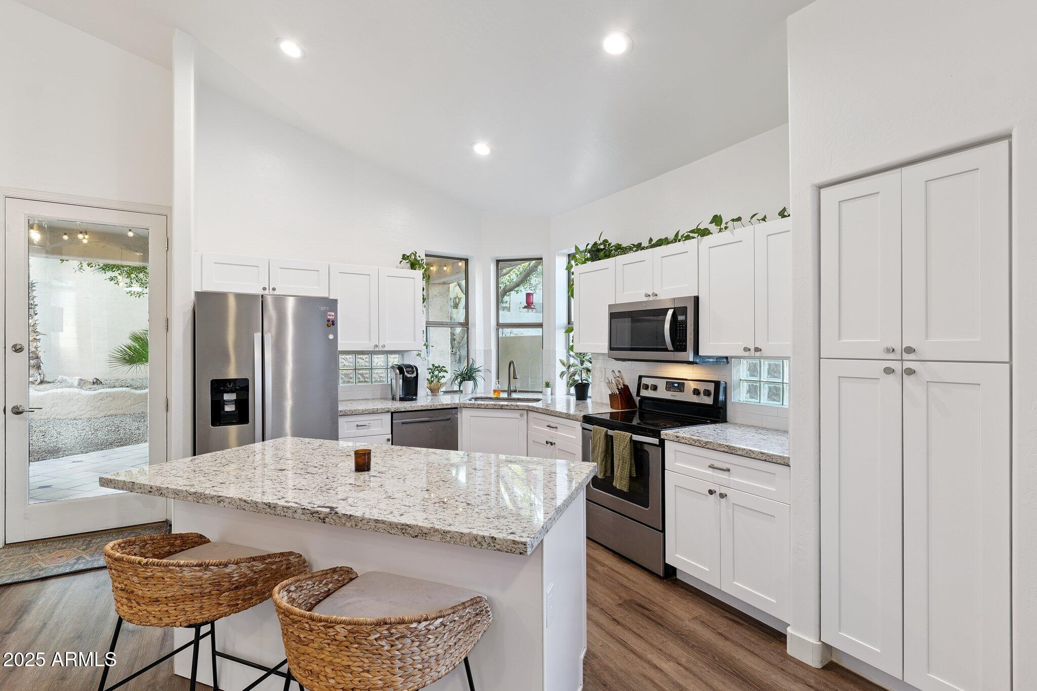 15608 South 7th Street Phoenix, AZ 85048 - Photo 7 of 30 a kitchen with stainless steel appliances granite countertop a refrigerator and microwave