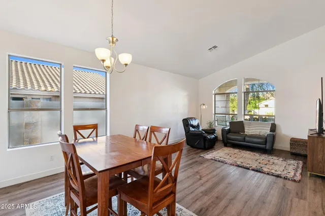 a living room with furniture a large window and a flat screen tv