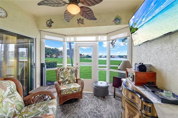 a living room with furniture and a floor to ceiling window