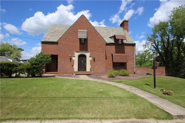 a front view of a house with a yard
