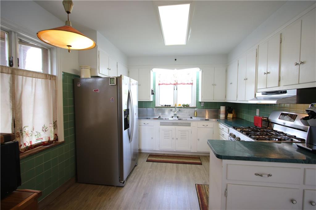 1121 Try Street Monongahela, PA 15063 - Photo 3 of 38 Spacious 13x11 Eat-in Kitchen w/ Plenty of Cabinets & partial Ceramic Tile Walls. Stainless Steel Sink w/ Prep area, Refrigerator & 5 Burner Gas Stove. Attractive Newer Flooring (2016 appx)